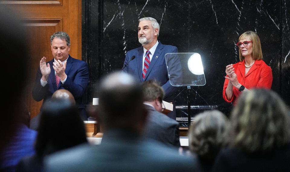 House Speaker Todd Huston, left, and Lt. Gov. Suzanne Crouch, right, clap as Gov. Eric Holcomb delivers his last State of the State address at the Indiana State Capitol in Indianapolis on Tuesday, Jan. 9, 2024.