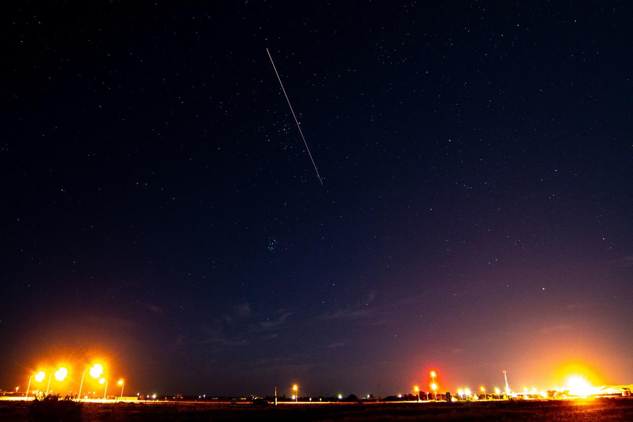 A long exposure shows the light trail of a re-entry capsule, carrying samples collected from a distant asteroid after being released by Japanese space probe Hayabusa-2, entering the Earth's atmosphere as seen from Coober Pedy in South Australia early on December 6, 2020. (Photo by Morgan Sette / AFP) (Photo by MORGAN SETTE/AFP via Getty Images)