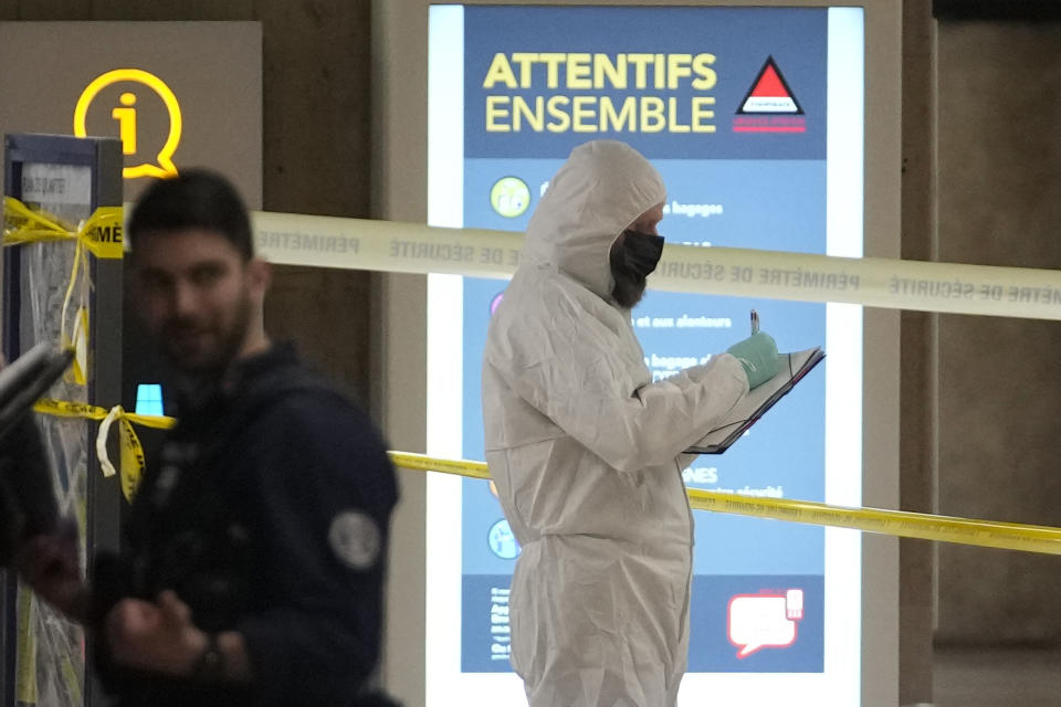 Police investigators work inside the Gare de Lyon station after an attack, Saturday, Feb. 3, 2024 in Paris. A man seemingly armed with a knife and a hammer injured three people Saturday in an early-morning attack at the major Gare de Lyon train station in Paris, another nerve-rattling security incident in the Olympic host city before the Summer Games open in six months. (AP Photo/Christophe Ena)