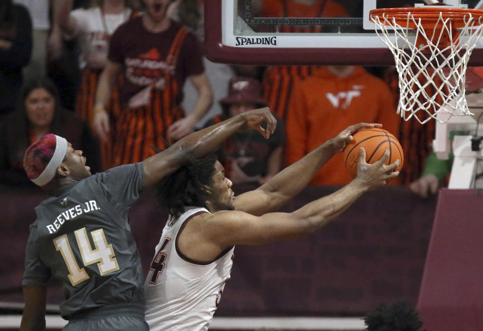 Virginia Tech's Mylyjael Poteat (34) is fouled by Georgia Tech's Kowacie Reeves, Jr (14) in the first half of an NCAA college basketball game, Saturday, Jan. 27, 2024, in Blacksburg, Va. (Matt Gentry/The Roanoke Times via AP)