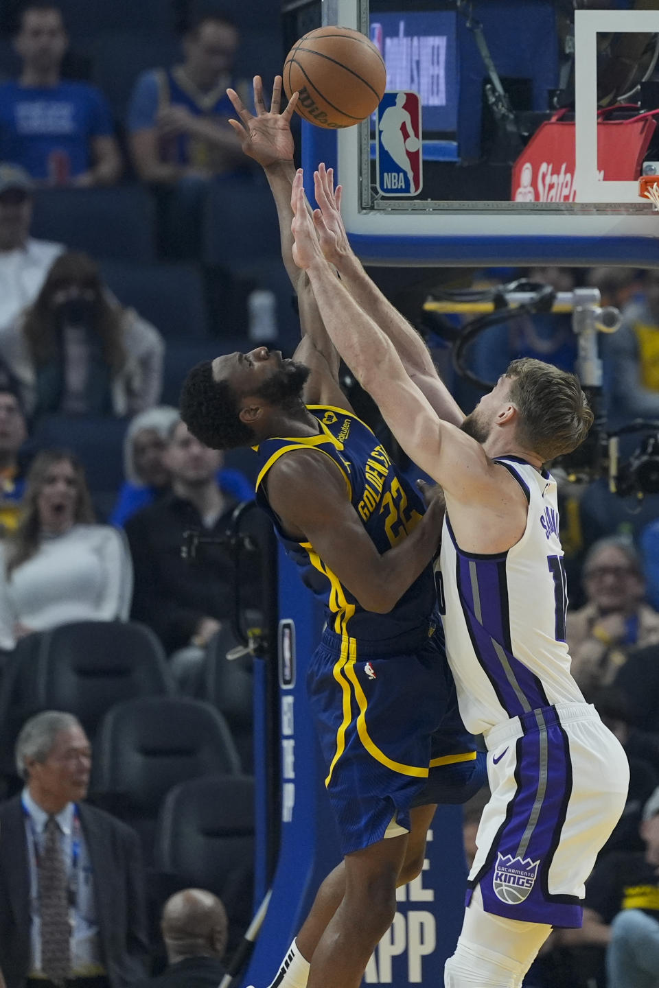 Golden State Warriors forward Andrew Wiggins, left, is fouled by Sacramento Kings center Domantas Sabonis, right, during the first half of an NBA basketball game Thursday, Jan. 25, 2024, in San Francisco. (AP Photo/Godofredo A. Vásquez)