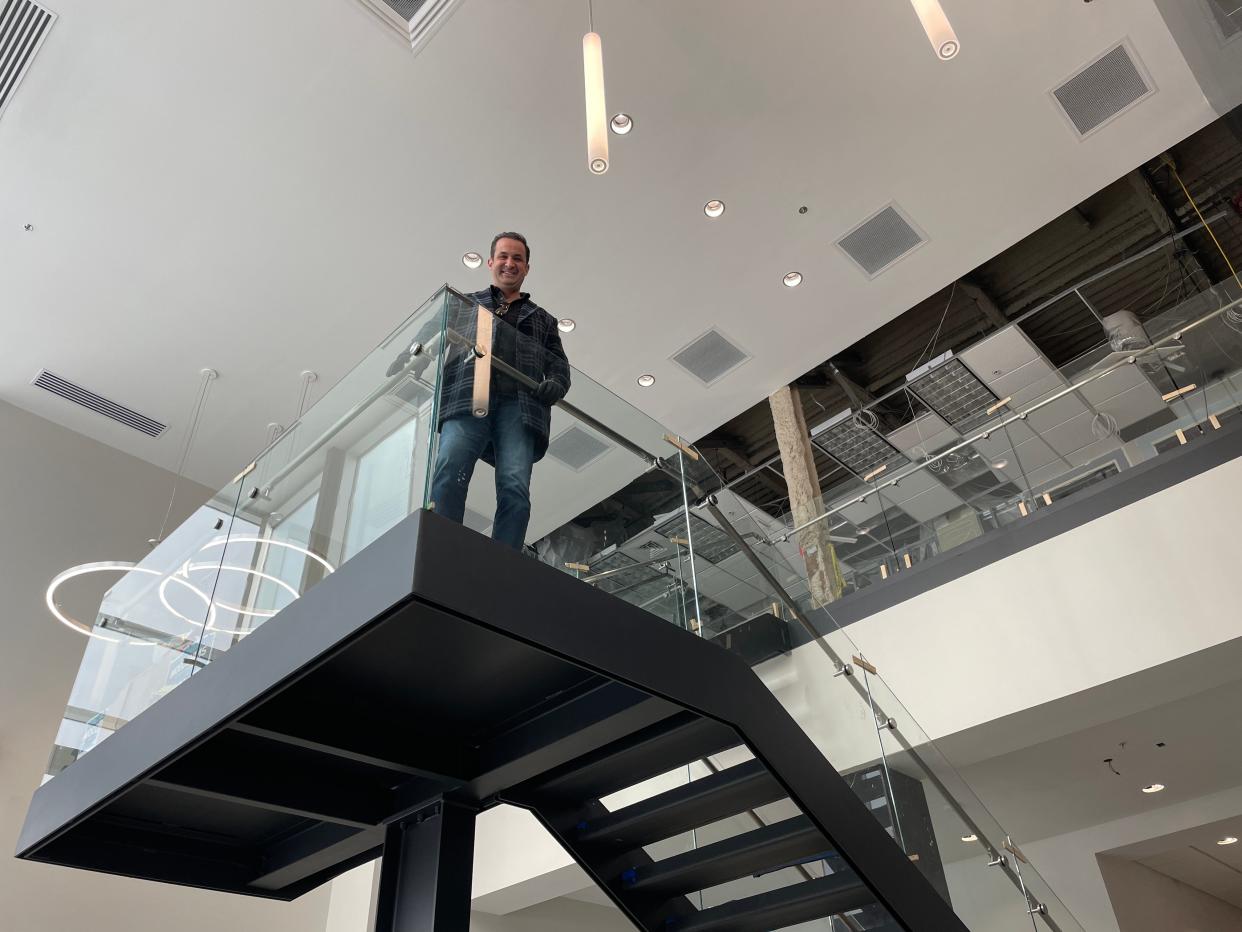 Joseph Schimizzi of Acquira Realty Holdings poses for a photo in the new atrium entrance of the "Howell Health Hub" on Tuesday, Jan. 16, 2024.