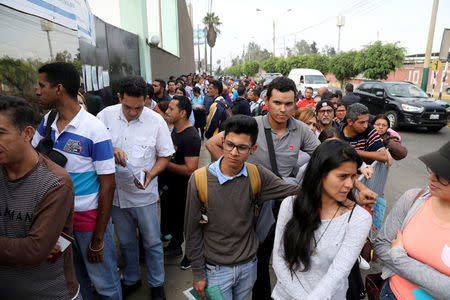 Venezuelan citizens queue to regularize their immigration papers at the Interpol office in Lima, Peru, May 10, 2018. REUTERS/Guadalupe Pardo