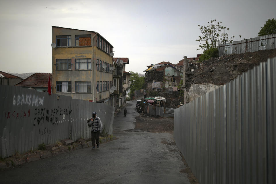 A person walks in Fatih neighborhood, during a strict lockdown to help curb the spread of the coronavirus, in Istanbul, Saturday, May 8, 2021. The "full lockdown," which began in late April and will last until May 17 came amid a huge surge in infections. (AP Photo/Emrah Gurel)