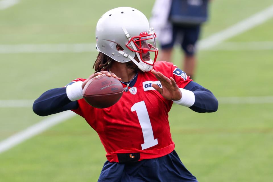 Jun 15, 2021; Foxborough, MA, USA; New England Patriots quarterback Cam Newton (1) participates in a drill during the New England Patriots mini camp at the New England Patriots practice complex. Mandatory Credit: Paul Rutherford-USA TODAY Sports