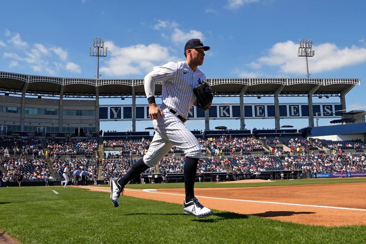 New York Yankees' Aaron Judge runs onto the field for the start of a spring training game on Sunday, Feb. 26, 2023, in Tampa, Fla. (AP Photo/David J. Phillip)