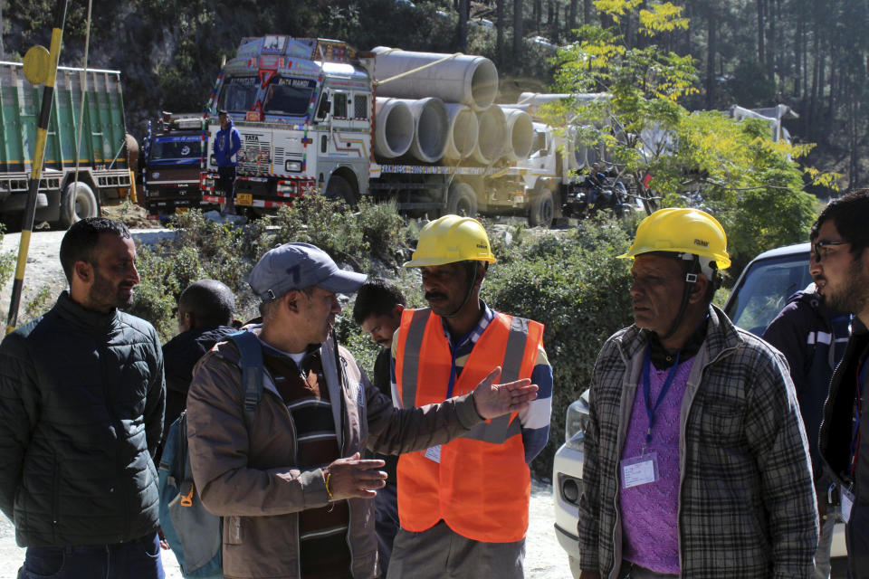 Rescuers gather at the site of an under-construction road tunnel that collapsed trapping 41 workers in Silkyara in the northern Indian state of Uttarakhand, Wednesday, Nov. 22, 2023. The workers have been trapped for over a week, as rescuers work on an alternate plan of digging toward them vertically. (AP Photo)
