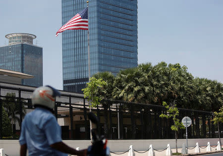 A man sits on his motorbike in front of the U.S. Embassy in Phnom Penh, Cambodia, April 14, 2018. REUTERS/Samrang Pring