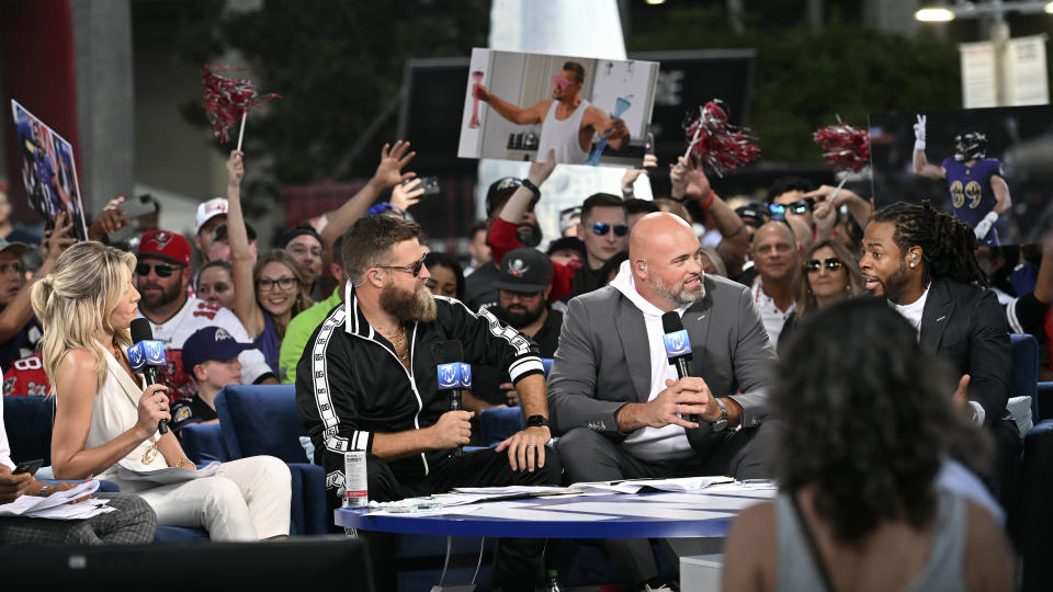 Thursday Night Football reporters, from left, Charissa Thompson, Ryan Fitzpatrick, Andrew Whitworth, and Richard Sherman talk before an NFL football game between the Baltimore Ravens and Tampa Bay Buccaneers Thursday, Oct. 27, 2022, in Tampa, Fla. (AP Photo/Jason Behnken)