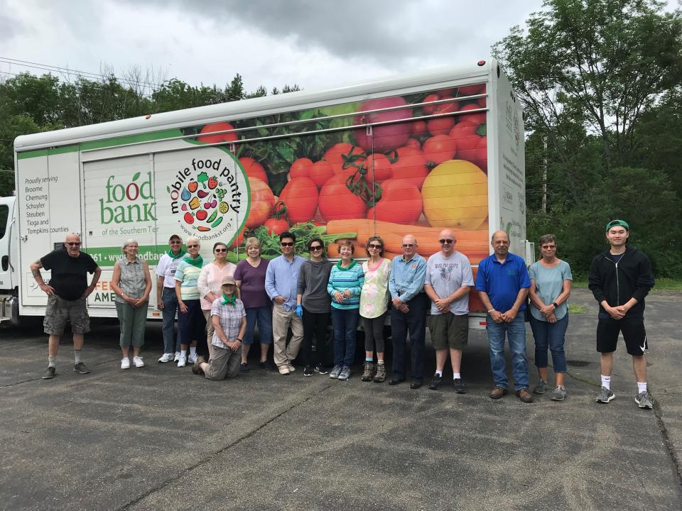 Members of the Union Center United Methodist Church volunteer at an outdoor food pantry last summer. The church recently opened an indoor food pantry.