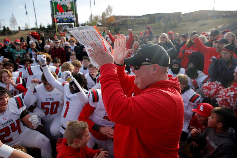 Carl Albert coach Mike Dunn celebrates with his team after winning the Class 5A state football championship last season in Edmond.