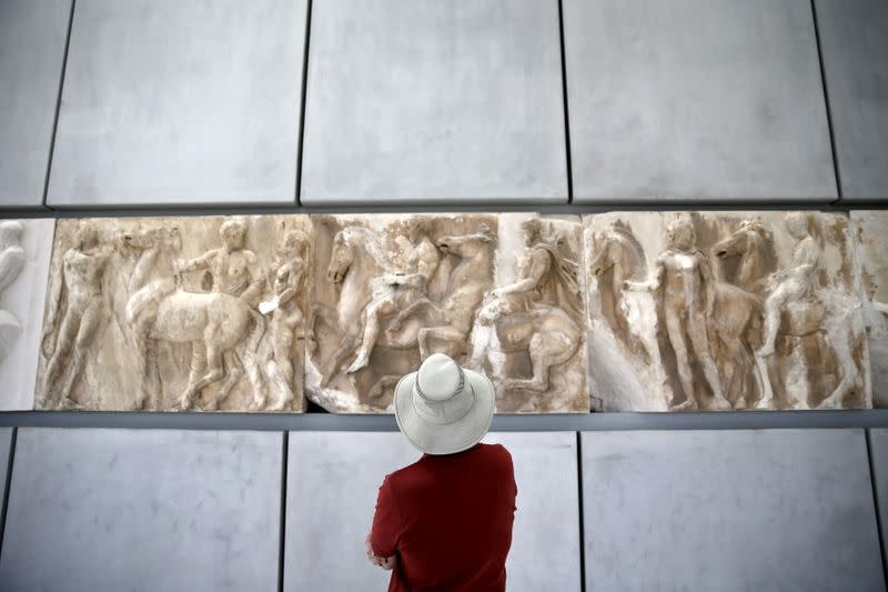 FILE PHOTO: A man looks at exhibits at the Parthenon hall of the Acropolis museum in Athens