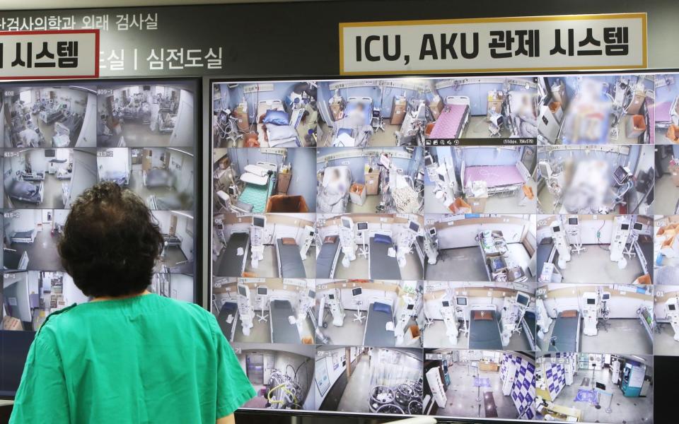 A medical worker looks at a screen showing negative pressure quarantine rooms at Bagae Hospital where patients infected with Covid-19 are treated - YONHAP/EPA-EFE/Shutterstock