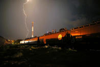 <p>Central American migrants stand atop a freight train headed north early on Aug. 4, 2013, in Arriaga, Mexico. (Photo: John Moore/Getty Images) </p>