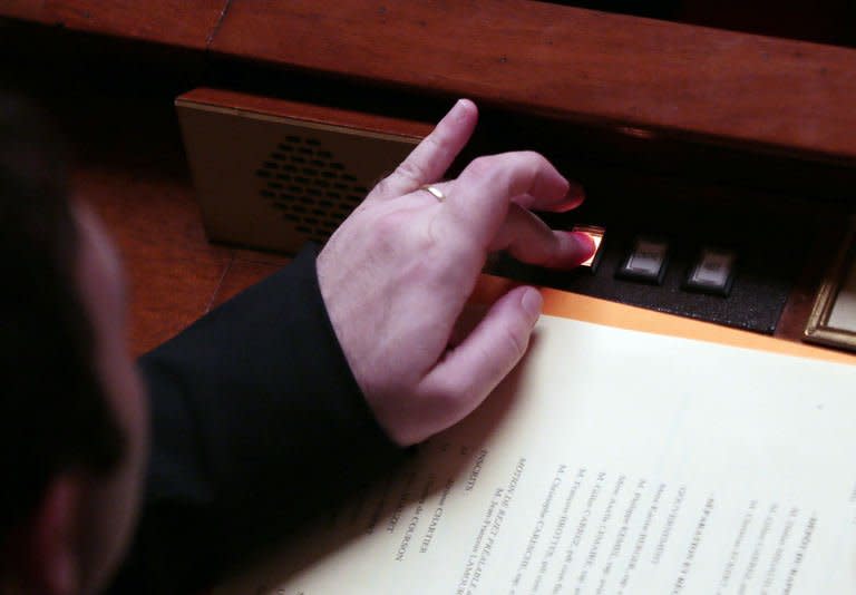 A French member of Parliament pushes a button to vote on February 12, 2013 at the French National Assembly in Paris. France on Tuesday came a step closer to legalising gay marriage when the lower house of parliament approved a highly controversial bill allowing same-sex couples to wed and adopt children