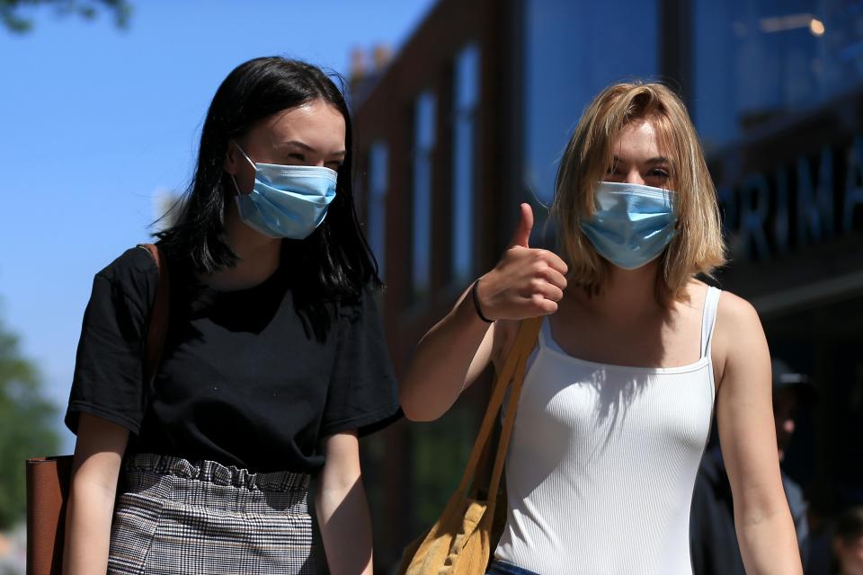 NORWICH, ENGLAND - JUNE 15: Shoppers give the thumbs up as they shop on the high street on June 15, 2020 in Norwich, United Kingdom. The British government have relaxed coronavirus lockdown laws significantly from Monday June 15, allowing zoos, safari parks and non-essential shops to open to visitors.  Places of worship will allow individual prayers and protective face masks become mandatory on London Transport.  (Photo by Stephen Pond/Getty Images)