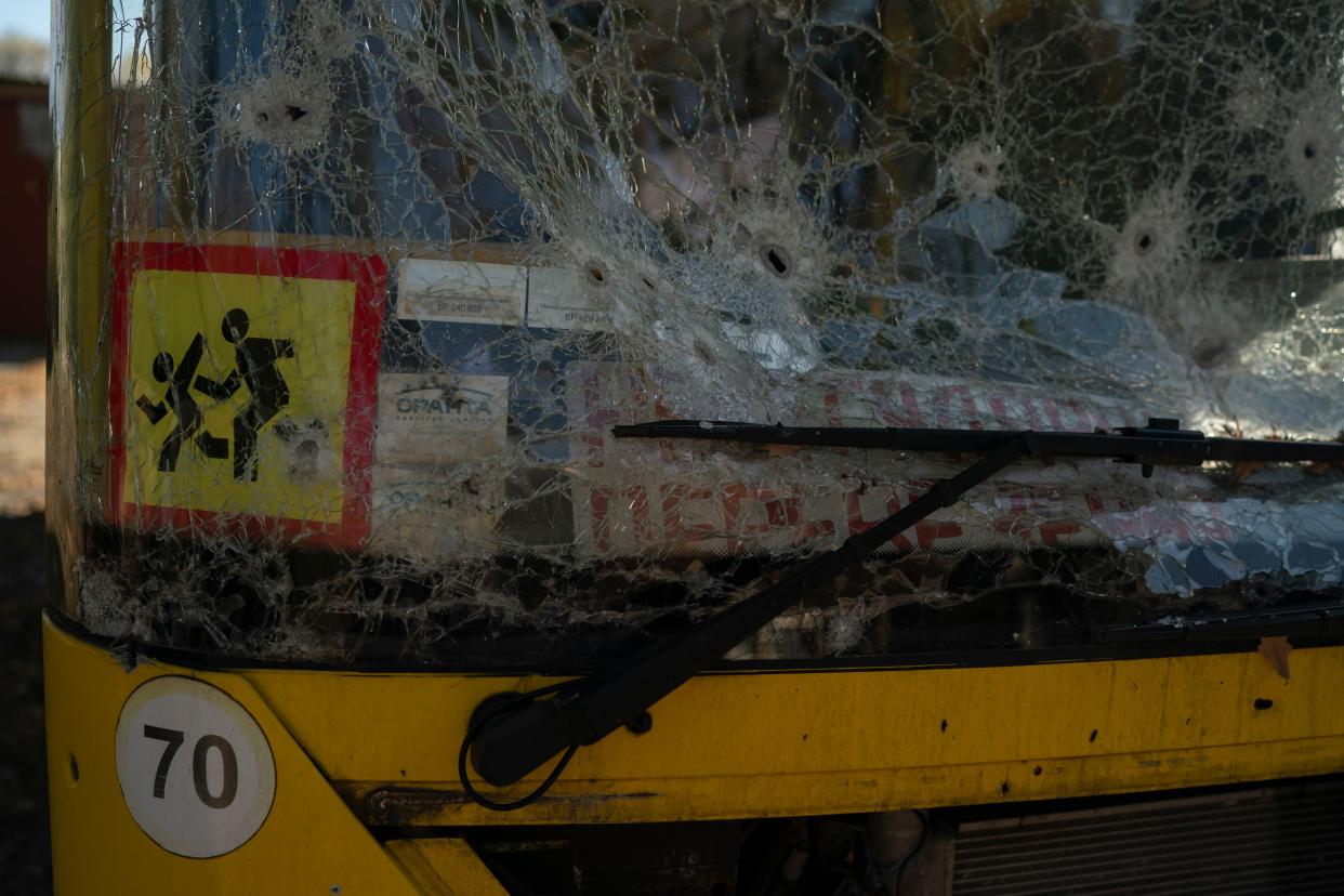 A damaged school bus is seen in the retaken village of Velyka Oleksandrivka, Ukraine, Wednesday, Oct. 12, 2022.