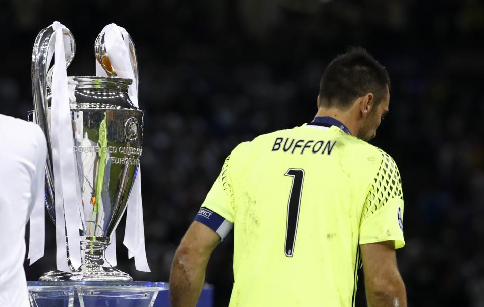<p>Juventus’ Gianluigi Buffon walks past the UEFA Champions League trophy after the match </p>