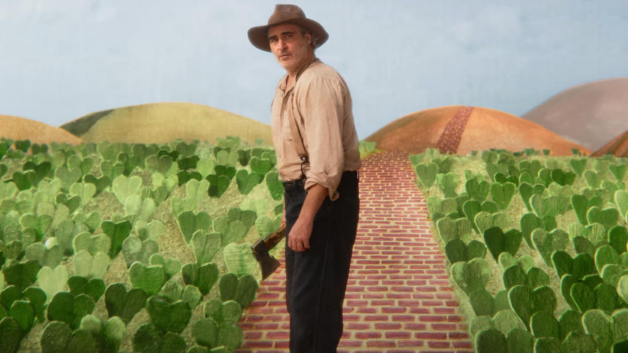  Joaquin Phoenix looks confused, dressed as a farmer in a colorful farm, in Beau Is Afraid. 