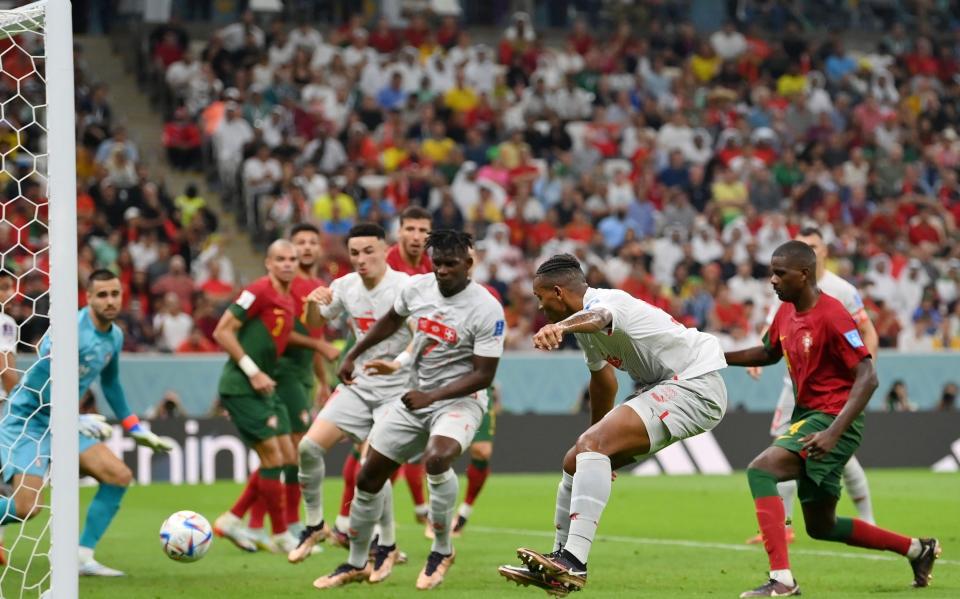 Manuel Akanji of Switzerland scores the team's first goal during the FIFA World Cup Qatar 2022 Round of 16 match - GETTY IMAGES