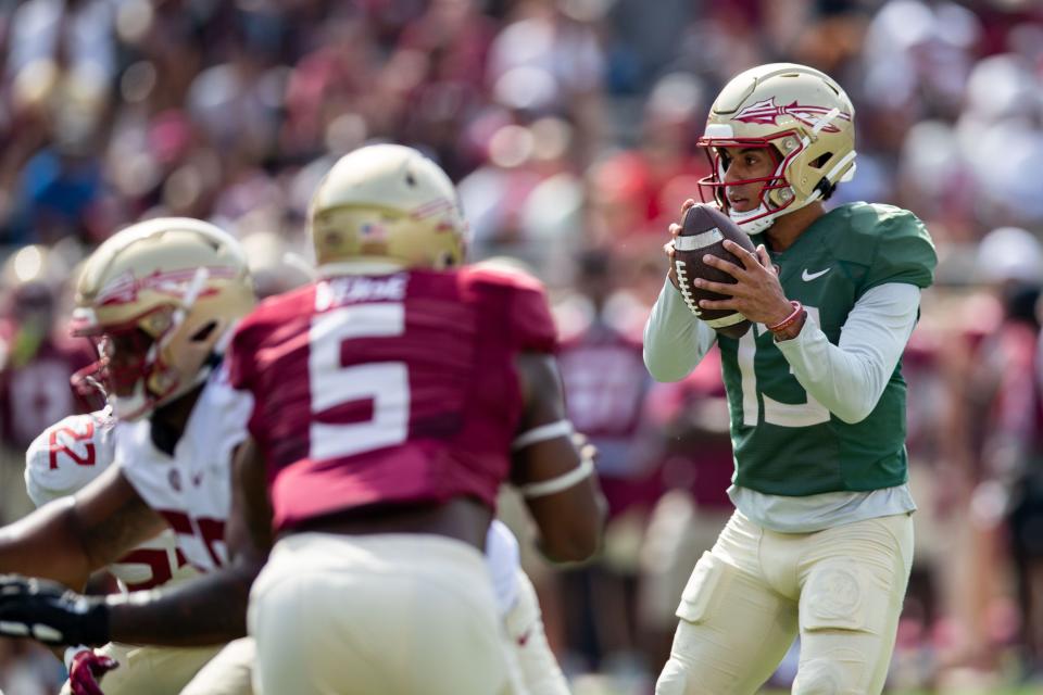 Florida State Seminoles quarterback <a class="link " href="https://sports.yahoo.com/ncaaf/players/289776" data-i13n="sec:content-canvas;subsec:anchor_text;elm:context_link" data-ylk="slk:Jordan Travis;sec:content-canvas;subsec:anchor_text;elm:context_link;itc:0">Jordan Travis</a> (13) looks to pass to a teammate down the field. Seminole fans watched as the <a class="link " href="https://sports.yahoo.com/ncaaf/teams/florida-st/" data-i13n="sec:content-canvas;subsec:anchor_text;elm:context_link" data-ylk="slk:Florida State football;sec:content-canvas;subsec:anchor_text;elm:context_link;itc:0">Florida State football</a> team hosted the FSU Garnet and Gold Spring Showcase on Saturday, April 15, 2023.<br>Fsu Spring Game001