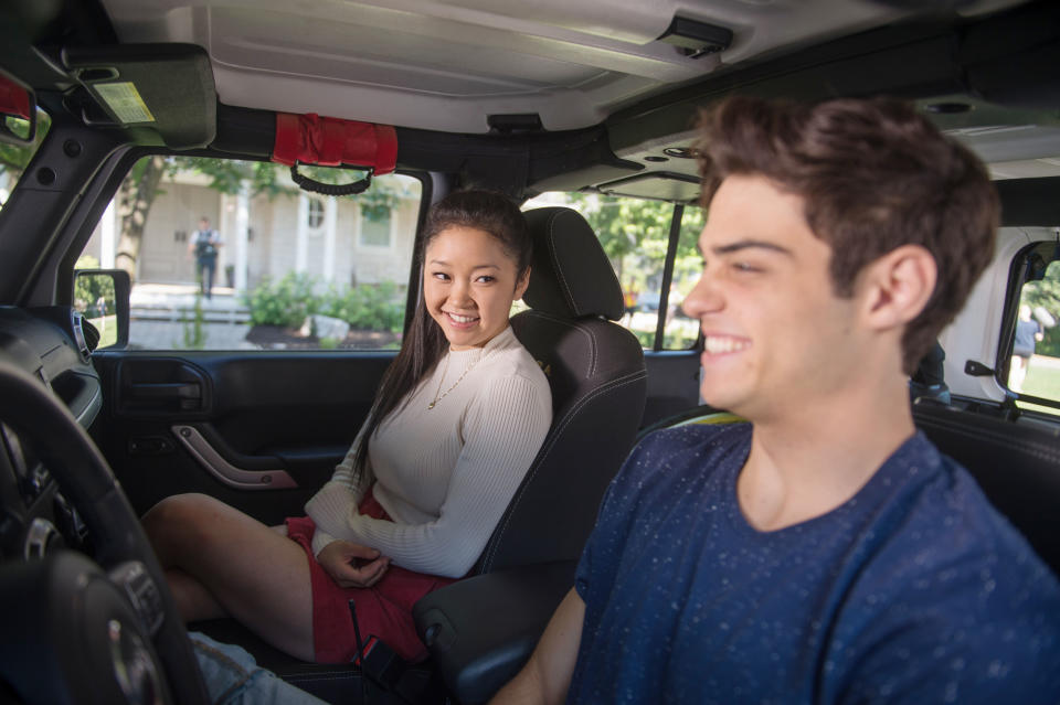 Lara Jean and Peter laugh in a car