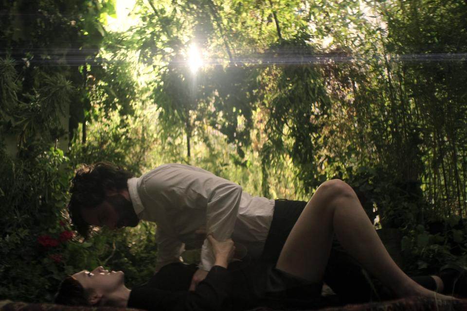 Kate Galvin (Charlotte Ritchie) and Joe Goldberg (Penn Badgley) get down in a garden in 'You' Season Four.