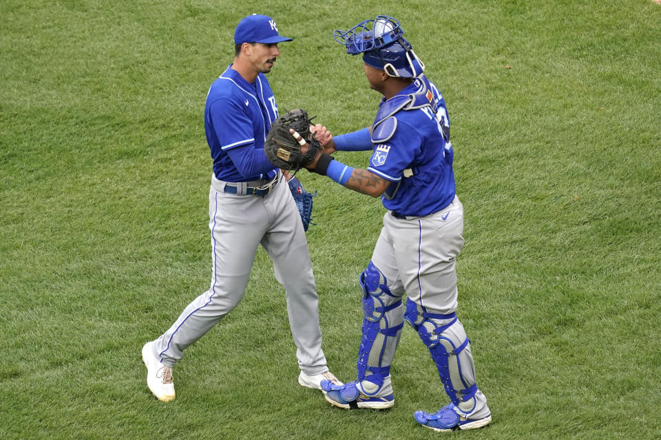 Kansas City Royals relief pitcher Kyle Zimmer, left, celebrates with catcher Salvador Perez after the Kansas City Royals defeated the Chicago White Sox in a baseball game in Chicago, Sunday, April 11, 2021. (AP Photo/Nam Y. Huh)