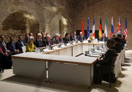 Negotiators of Iran and six world powers face each other at a table in the historic basement of Palais Coburg hotel in Vienna April 24, 2015. REUTERS/Heinz-Peter Bader