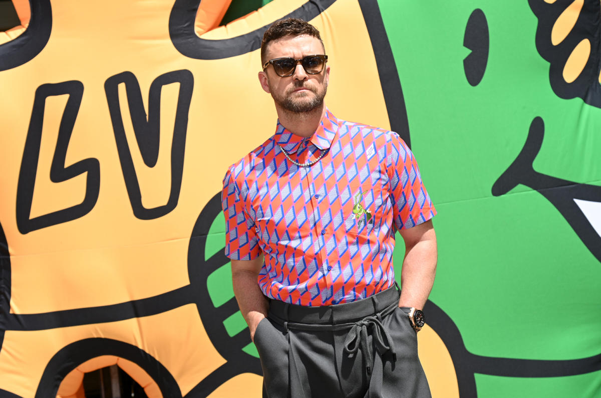 Justin Timberlake holds a PURSE as he poses for the new Louis Vuitton  collab