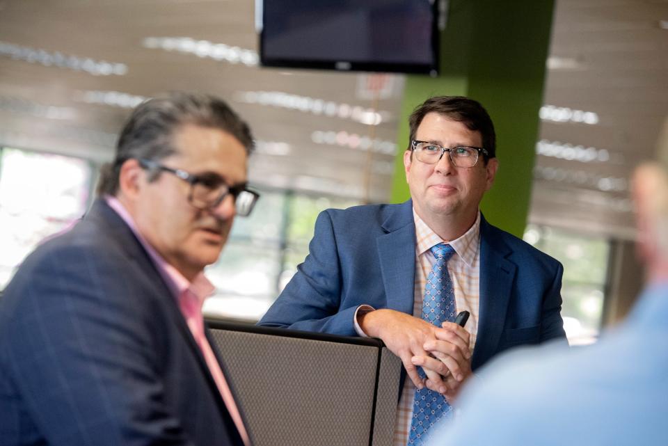 Mark Konradi, center, long-time veteran of the Dallas Morning News, listens as USA TODAY Network Regional Editor Michael Anastasi, left, speaks with staff announcing Konradi as the new executive editor of the Clarion Ledger in Jackson, Miss., Wednesday, July 27, 2022.