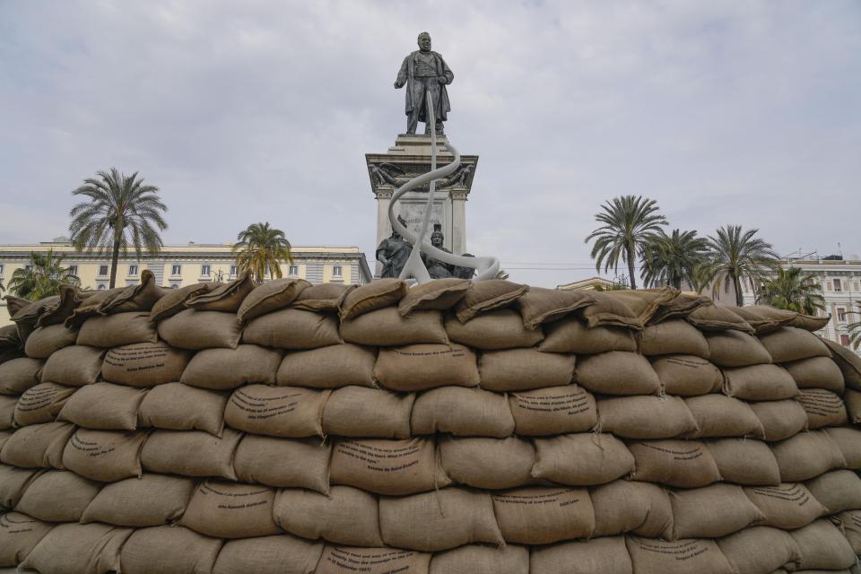 Peace quotations printed on the jute bags are displayed as part of an installation by Italian artist Gianfranco Meggiato titled "The Meeting; The Symbol of Peace" to mark the first anniversary of Russia's full-scale invasion of Ukraine, in Rome, Friday, Feb. 24, 2023. (AP Photo/Gregorio Borgia)