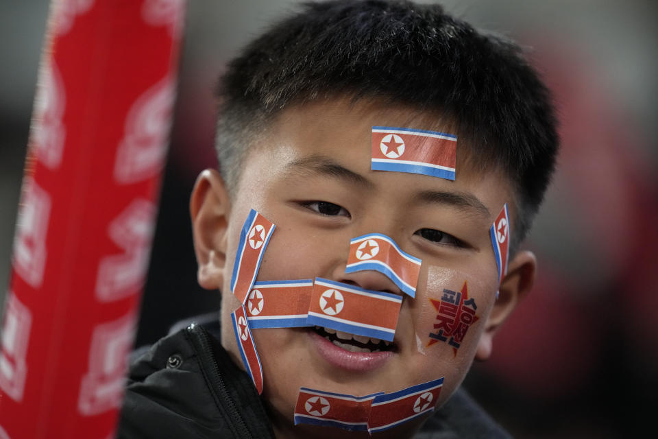 A fan has pasted North Korean flags on his face ahead of the FIFA World Cup 2026 and AFC Asian Cup 2027 preliminary joint qualification round 2 match between Japan and North Korea at the National Stadium Thursday, March 21, 2024, in Tokyo. (AP Photo/Eugene Hoshiko)