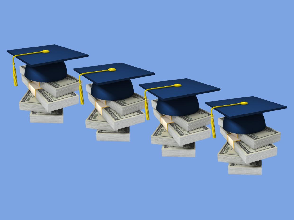 graduation caps on stacks of money