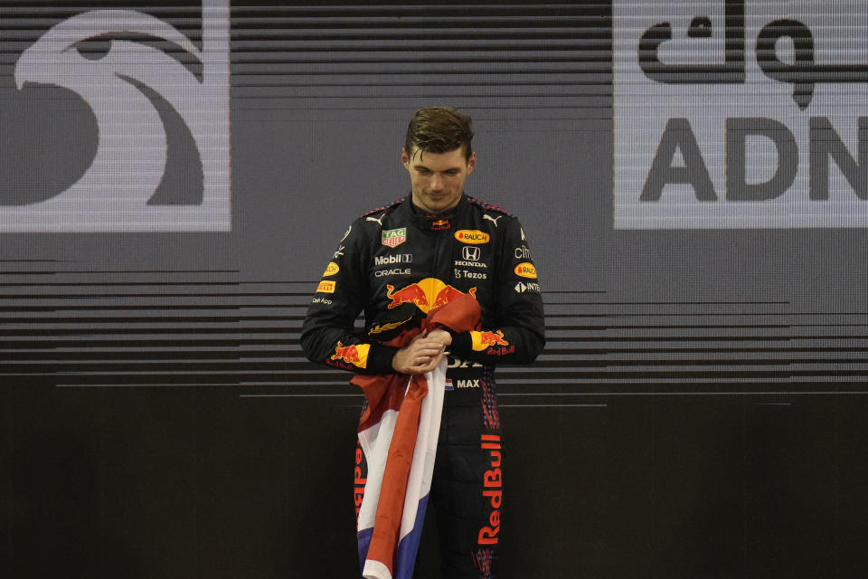 Red Bull driver Max Verstappen of the Netherlands stand on the podium after he became the world champion after winning the Formula One Abu Dhabi Grand Prix in Abu Dhabi, United Arab Emirates, Sunday, Dec. 12, 2021. (AP Photo/Hassan Ammar)