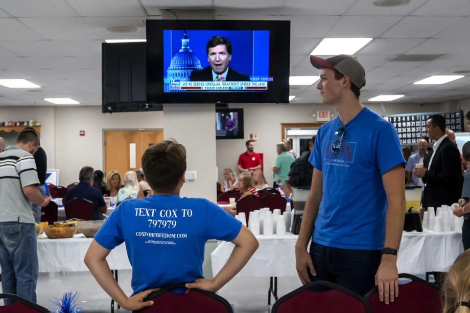 <div class="inline-image__caption"><p>Supporters of Dan Cox, a candidate for the Republican gubernatorial nomination, watch Tucker Carlson on July 19 in Emmitsburg, Maryland.</p></div> <div class="inline-image__credit">Nathan Howard/Getty</div>