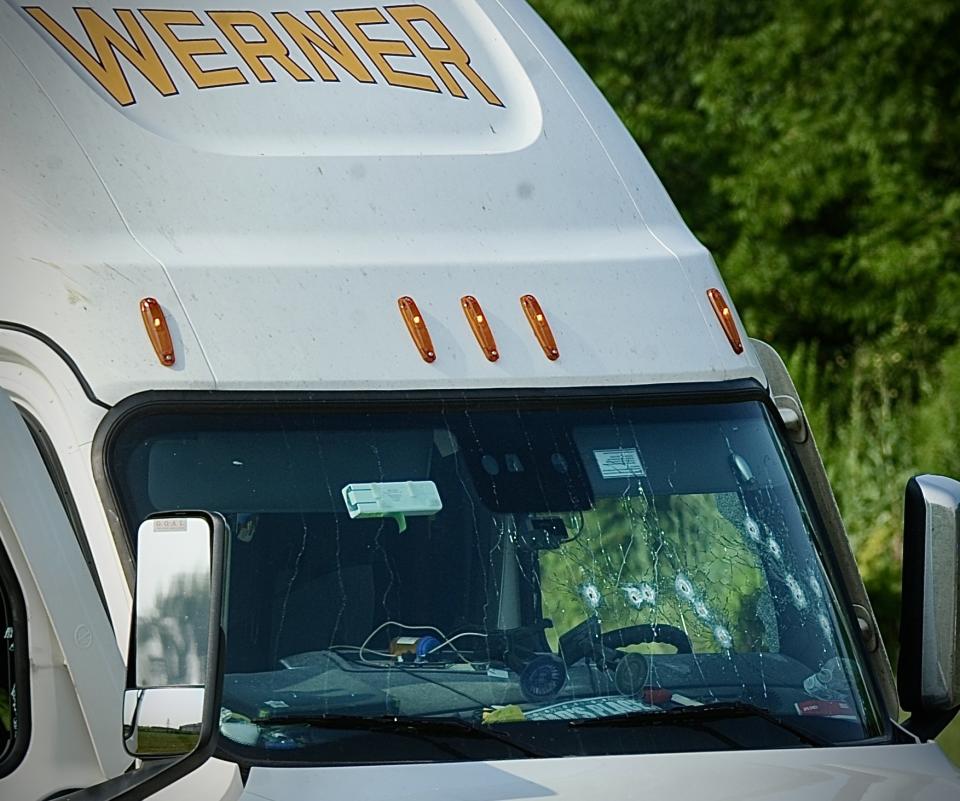 The windshield of a Werner truck is riddled with bullet holes after two suspects kidnapped a truck driver. (Photo credit: Marshall Gorby, Dayton Daily News)