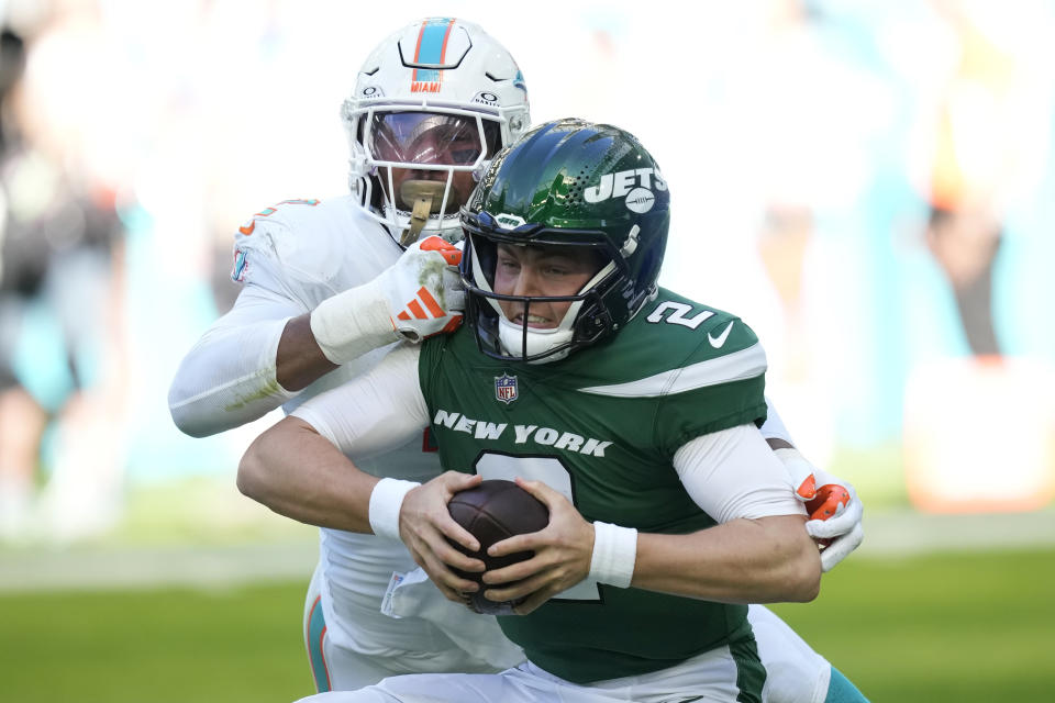 New York Jets quarterback Zach Wilson (2) is sacked by Miami Dolphins linebacker Bradley Chubb (2) during the first half of an NFL football game, Sunday, Dec. 17, 2023, in Miami Gardens, Fla. (AP Photo/Rebecca Blackwell)