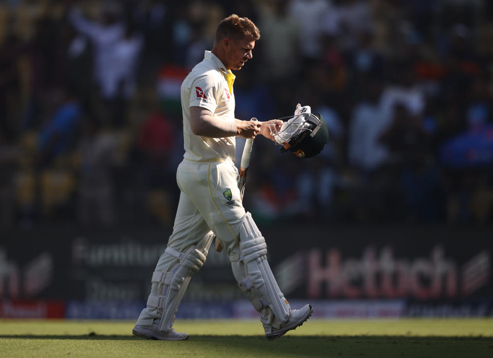 David Warner (pictured) walks off after being bowled.