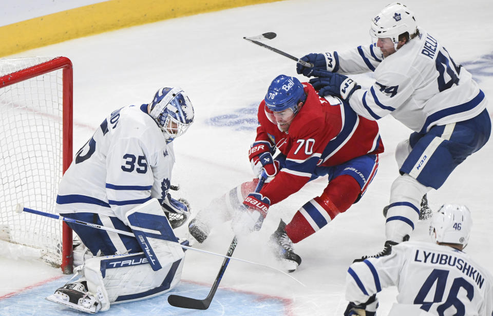Montreal Canadiens' Tanner Pearson (70) moves in on Toronto Maple Leafs goaltender Ilya Samsonov (35) as Maple Leafs' Morgan Rielly (44) defends during the third period of an NHL hockey game in Montreal, Saturday, April 6, 2024. (Graham Hughes/The Canadian Press via AP)