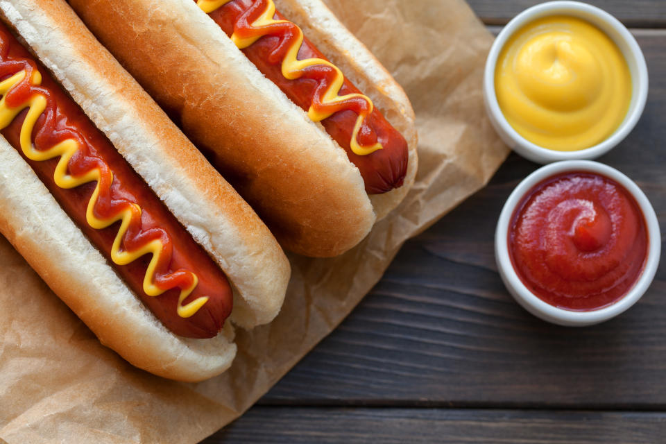 Barbecue Grilled Hot Dog with Yellow Mustard on wooden table