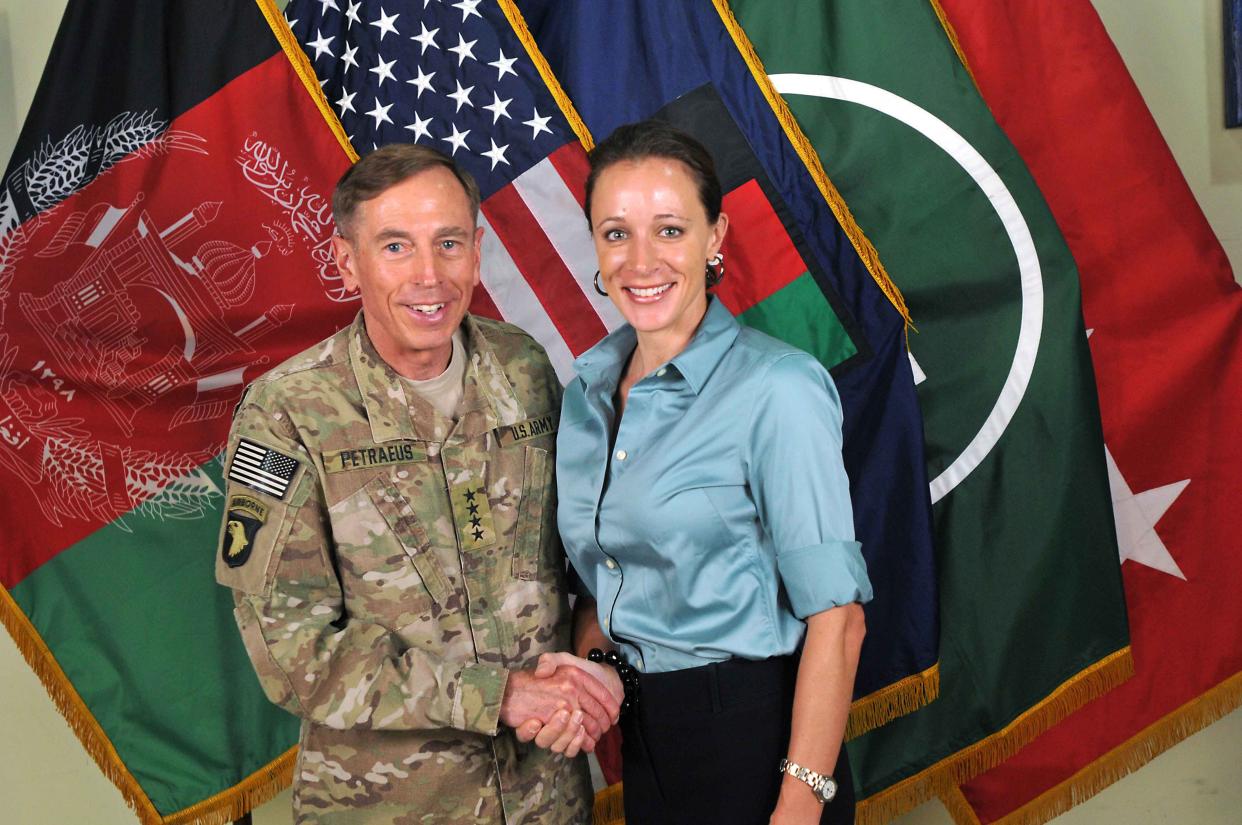 CIA Director Gen. Davis Petraeus (L) shakes hands with biographer Paula Broadwell, co-author of "All In: The Education of General David Petraeus" on July 13, 2011.