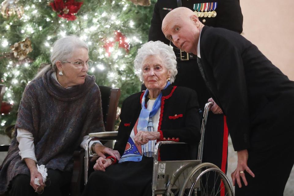 Annie Glenn, center, arrives to view the casket of her husband John Glenn alongside her daughter Carolyn Ann Glenn, left, and son David, right, as he lies in honor, Friday, Dec. 16, 2016, in Columbus, Ohio. Glenn's home state and the nation began saying goodbye to the famed astronaut who died last week at the age of 95. (AP Photo/John Minchillo)