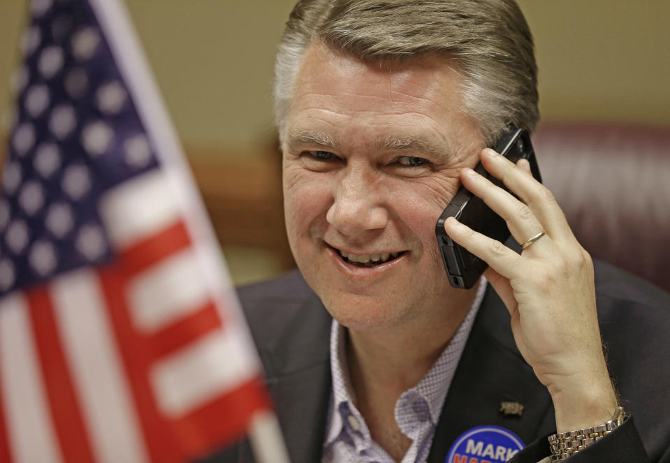 Republican Senate candidate Mark Harris smiles as he talks to a voter as he makes phone bank calls from his headquarters in Charlotte, N.C., Monday, May 5, 2014. The struggle for control of the Republican Party gets an early voter test in North Carolina, where GOP leaders Mitt Romney and Rand Paul push candidates competing against Democratic Sen. Kay Hagan in the November midterm elections. (AP Photo/Chuck Burton)