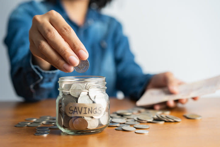 a jar of coins with the label "Savings" on it