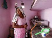 Munesh Nagar, a housewife, cooks on a stove using a Liquefied Petroleum Gas (LPG) cylinder in her kitchen at Dujana village in Noida, on the outskirts of New Delhi October 7, 2015. REUTERS/Anindito Mukherjee