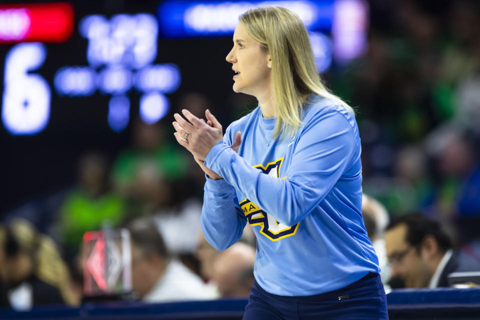 Marquette head coach Megan Duffy claps during the first half of a first-round college basketball game against Mississippi in the NCAA Tournament Saturday, March 23, 2024, in South Bend, Ind. (AP Photo/Michael Caterina)