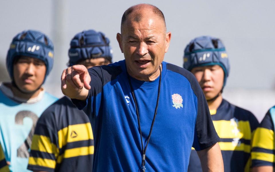 Eddie Jones leading a rugby practice session with Japanese schoolchildren during the 2019 Rugby World Cup