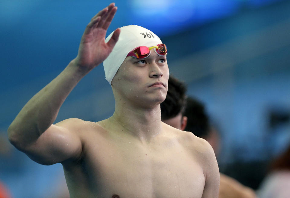 FILE - In this Friday, July 26, 2019 file photo, China's Sun Yang waves following the men's 4x200m freestyle relay heats at the World Swimming Championships in Gwangju, South Korea. Ahead of a verdict pending within days in the doping case of three-time Olympic champion Sun Yang, a Swiss supreme court document on Tuesday, Feb. 25, 2020 shows swimming’s governing body wanted to stop the World Anti-Doping Agency’s appeal. World swim body FINA supported arguments by Sun’s lawyers who asked the Court of Arbitration for Sport to throw out WADA’s case early last year in a pre-trial dispute over an alleged conflict of interest for the agency’s American lead prosecutor, Richard Young. (AP Photo/Mark Schiefelbein, file)