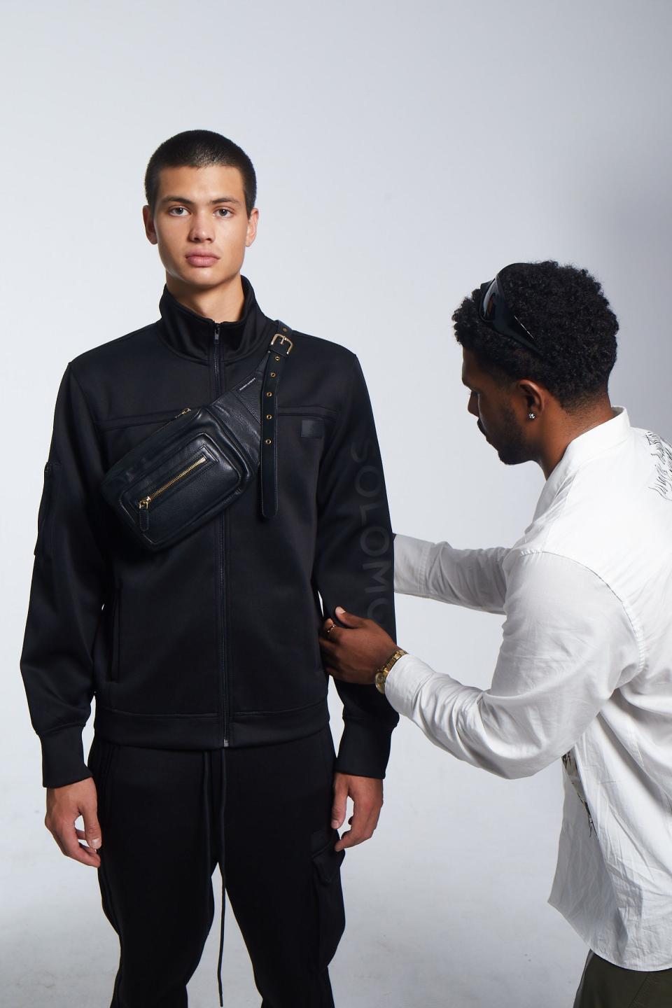 Designer Issac Lawrence styles model Tanner Agpoon wearing Solomon Lawrence's tracksuit in black, featured in the label's 2024 Spring New York Fashion Week collection.